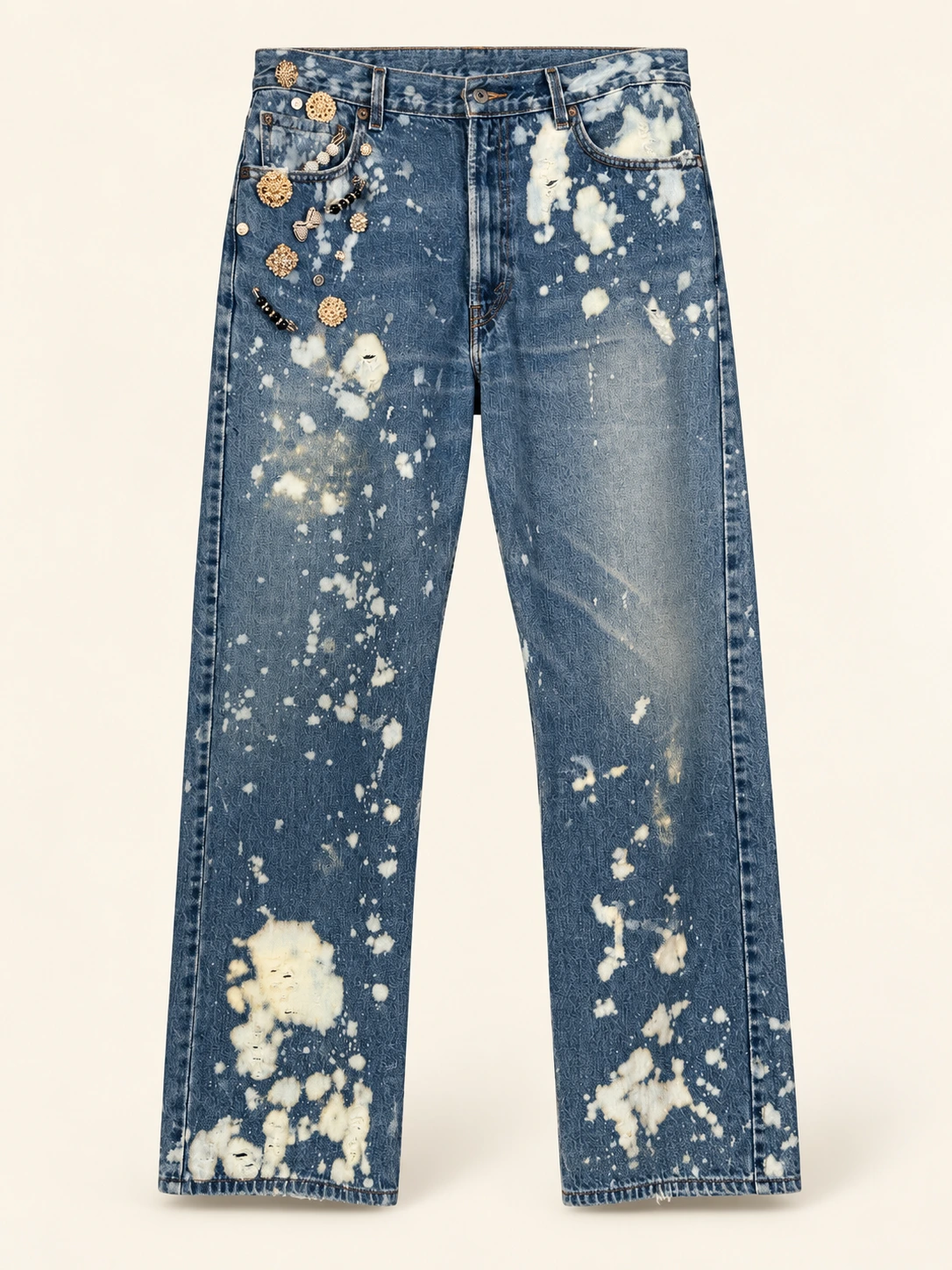 Blue bleach-splashed jeans with decorative brooches at the hip